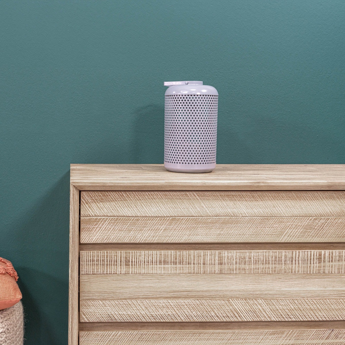 Close-up of the Gia dresser top surface showing the steel-brushed acacia wood grain texture with a small speaker placed on top