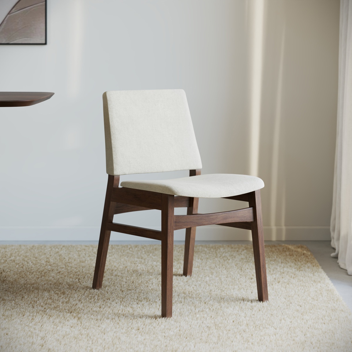 Eira Dining Chair in ivory fabric and walnut-finish oak frame styled in a neutral modern dining room