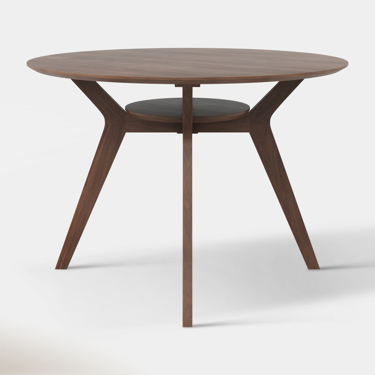 Front-facing product view of the Ansel Dining Table showing the walnut lower shelf, angled legs, and round tabletop
