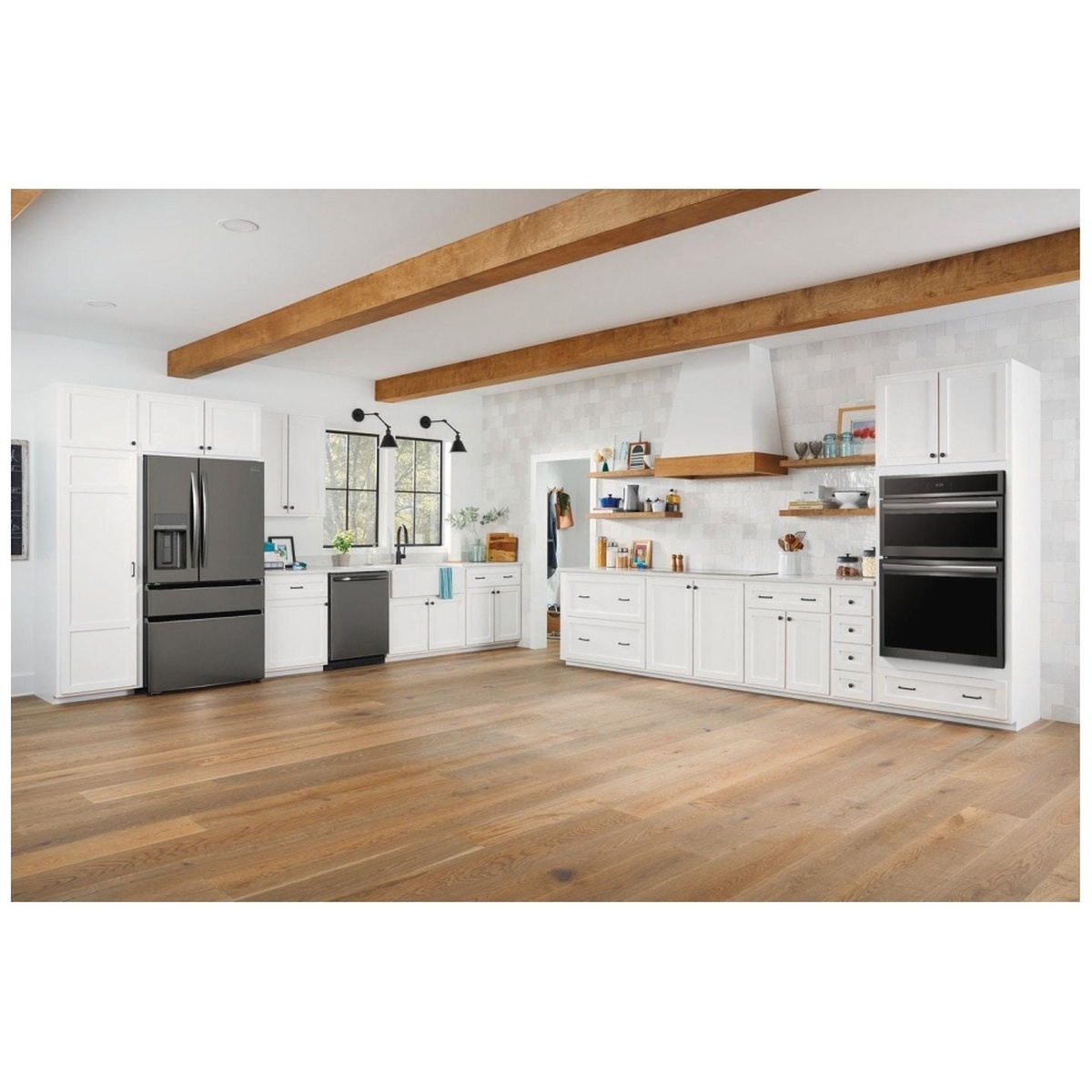 Modern white kitchen with a built-in wall oven and microwave combo installed in tall cabinetry