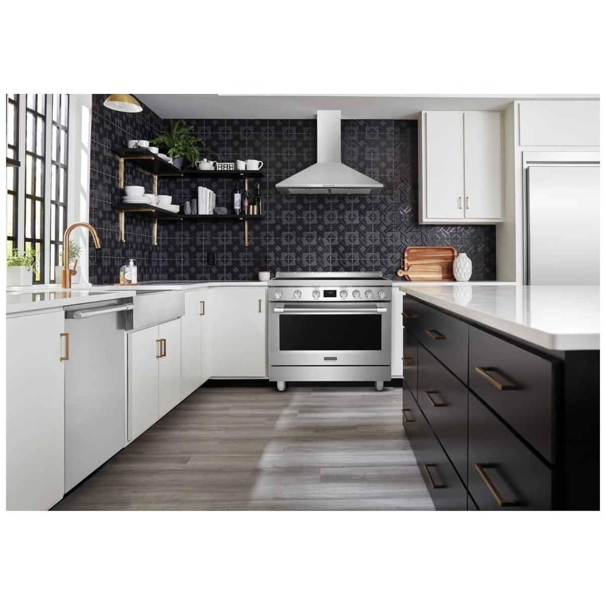 Frigidaire Professional PCFI3670AF induction range installed in a modern kitchen with dark tile backsplash, white cabinetry, and a wall-mounted range hood
