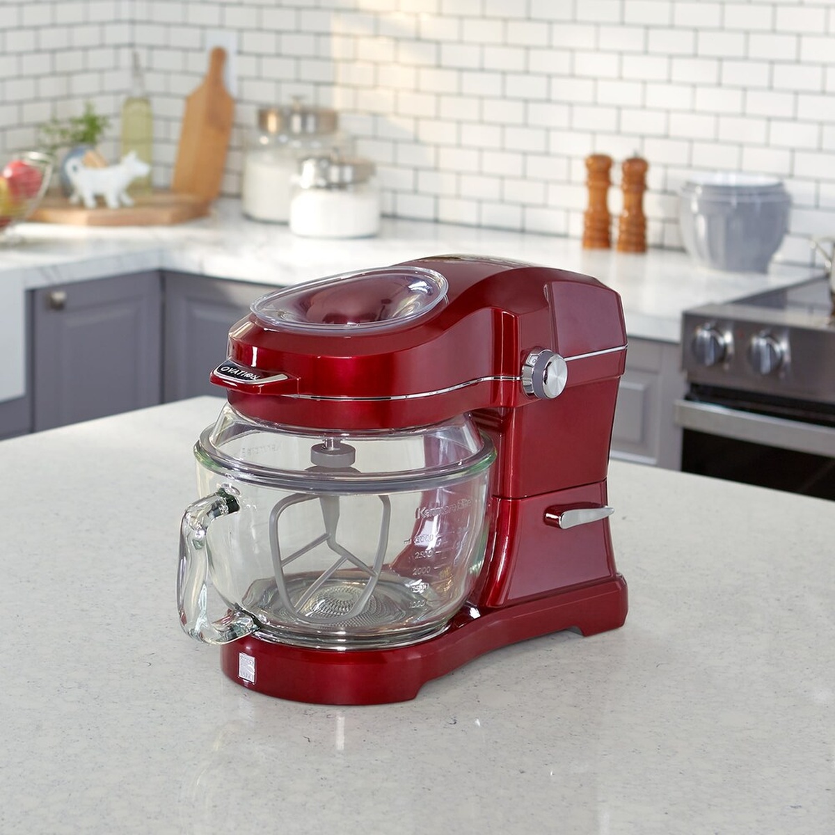 Red Kenmore Elite Ovation stand mixer with a glass bowl on a kitchen counter