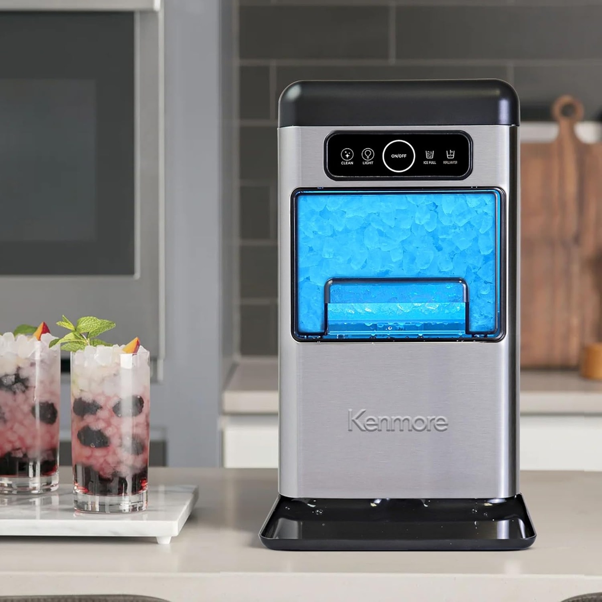 Kenmore nugget ice maker on a kitchen counter next to prepared drinks