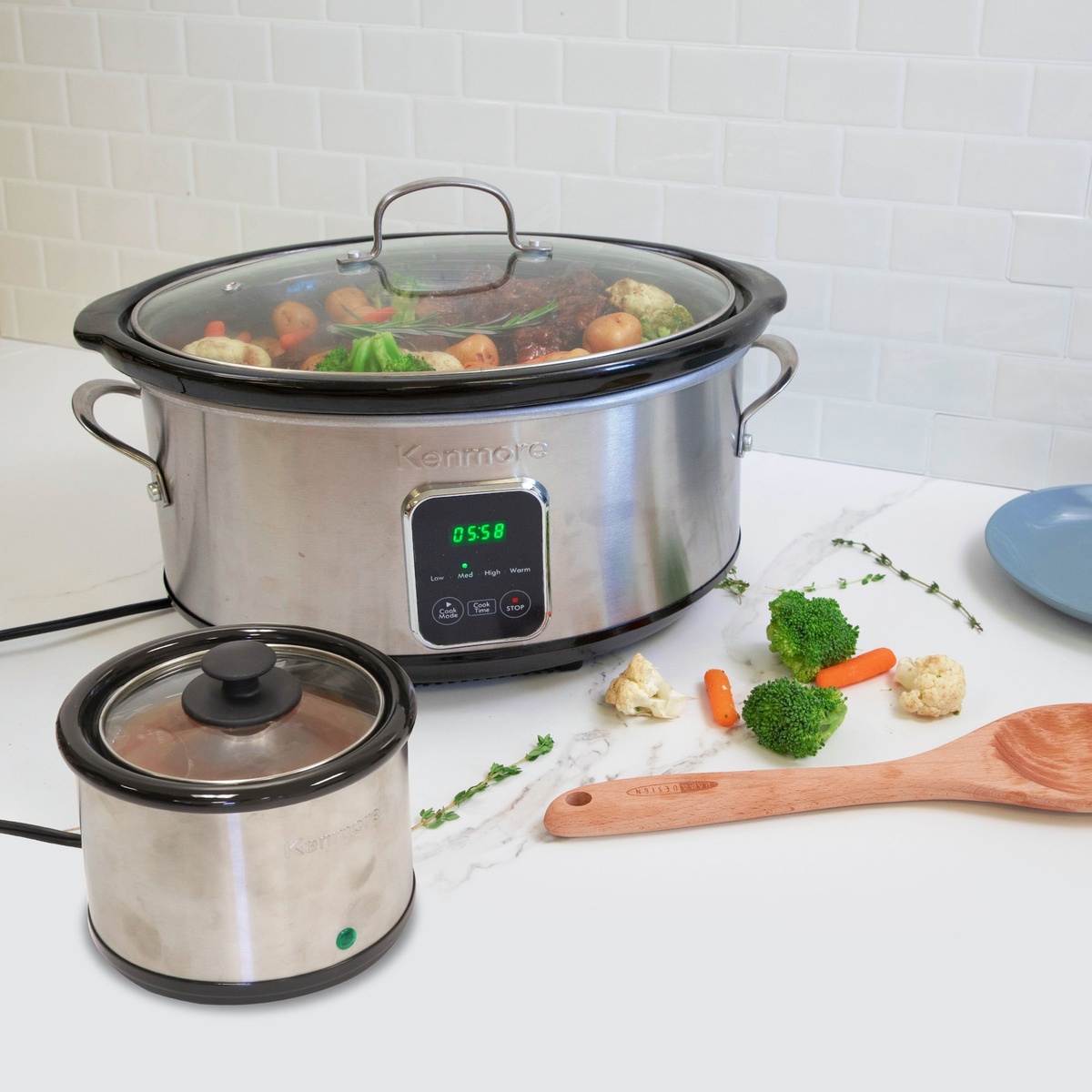 Kenmore slow cooker and dip warmer on a kitchen counter with food, showing the digital timer