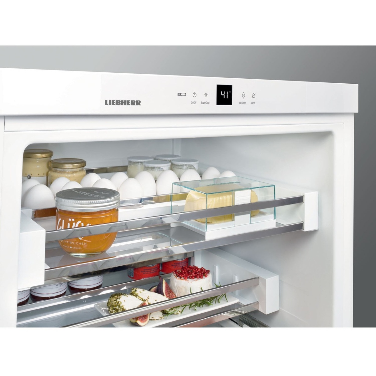 Close-up of the Liebherr UPR513 interior showing GlassLine shelves loaded with food items and the touch-electronic control panel with digital temperature display at top