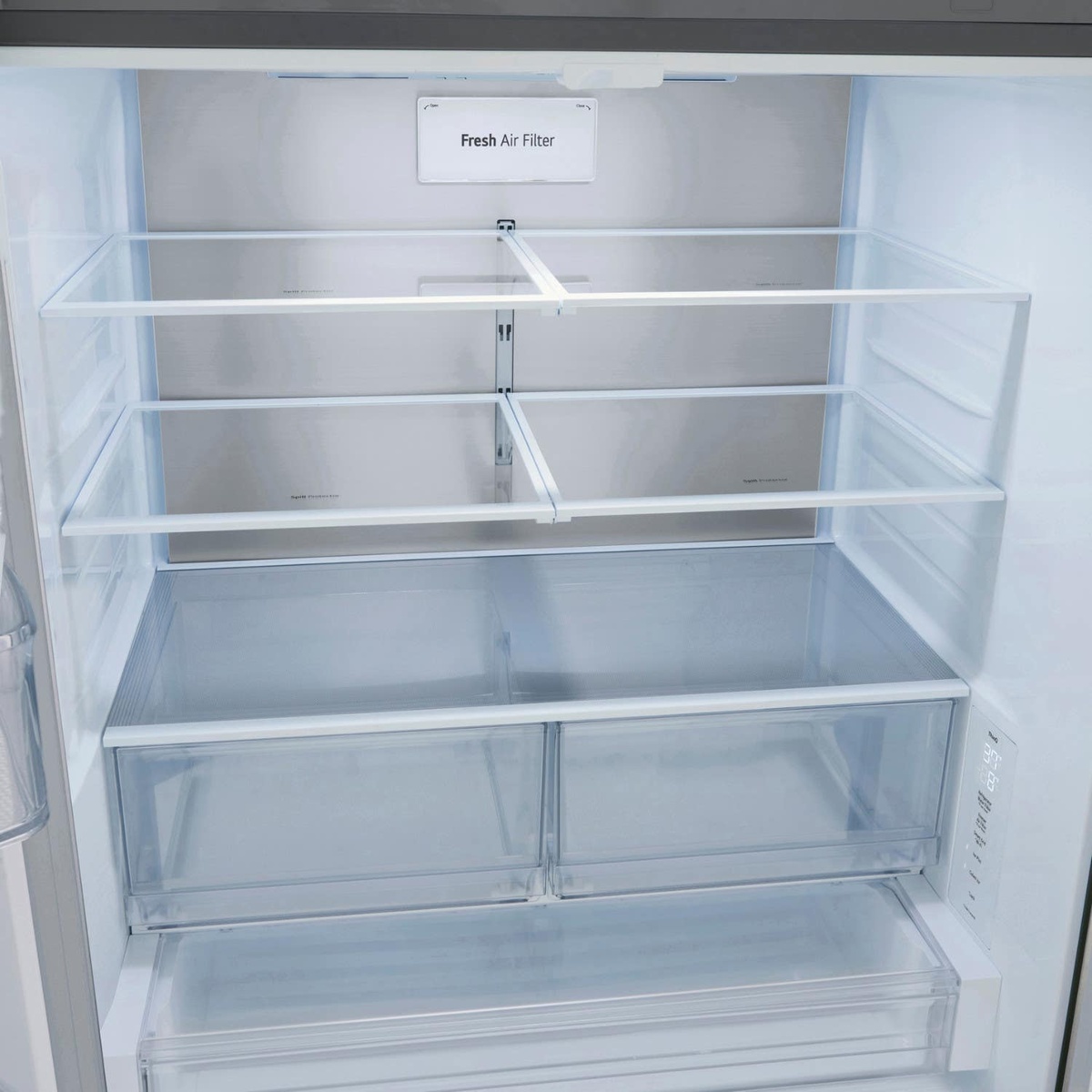 Interior of LG refrigerator showing Fresh Air Filter, adjustable glass shelves, and clear crisper drawers with LED lighting