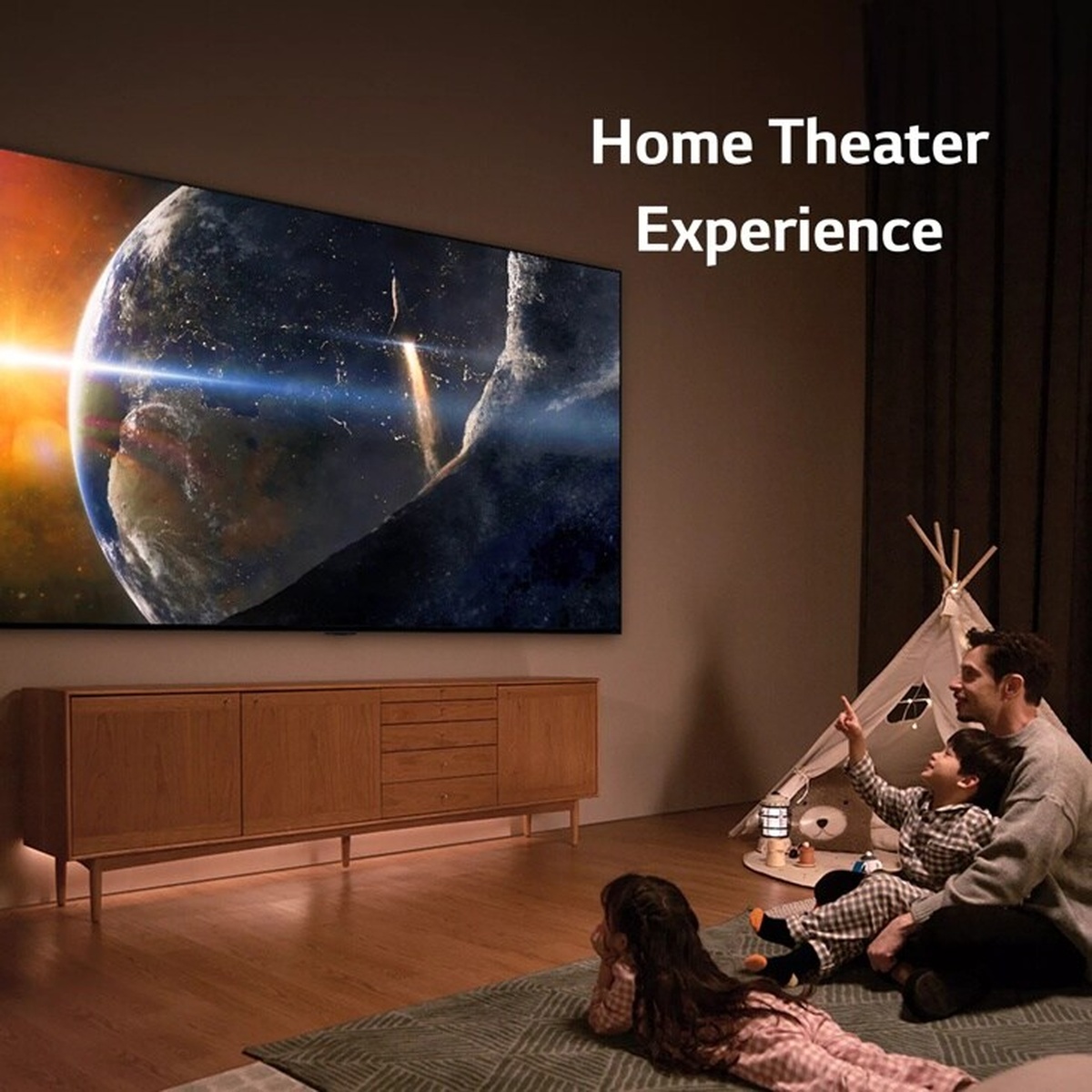 Family watching a large LG TV mounted on a living room wall displaying a cinematic space scene, with text reading Home Theater Experience