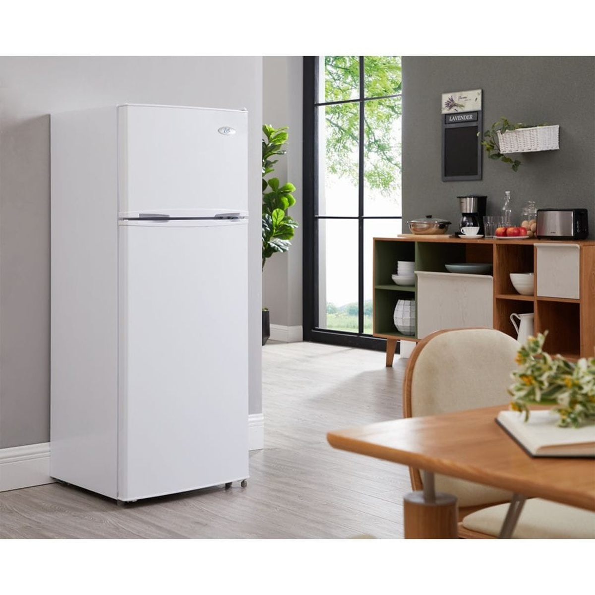Epic ER82W-1 white top-freezer refrigerator standing in a bright modern kitchen and dining area