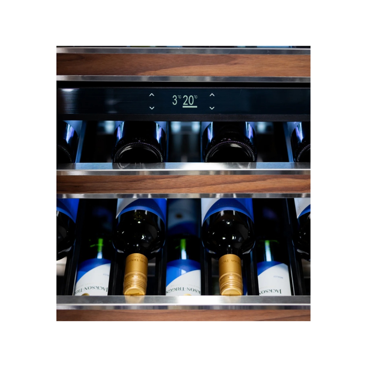Interior of Stirling dual-zone wine cooler showing wine bottles on stainless shelves with illuminated TFT touch display showing zone temperatures