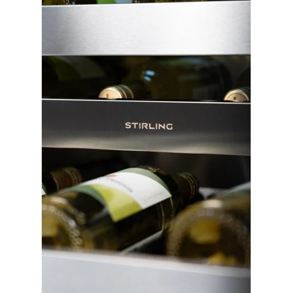 Close-up of Stirling branded brushed stainless steel shelf divider inside a wine cooler with wine bottles visible behind it