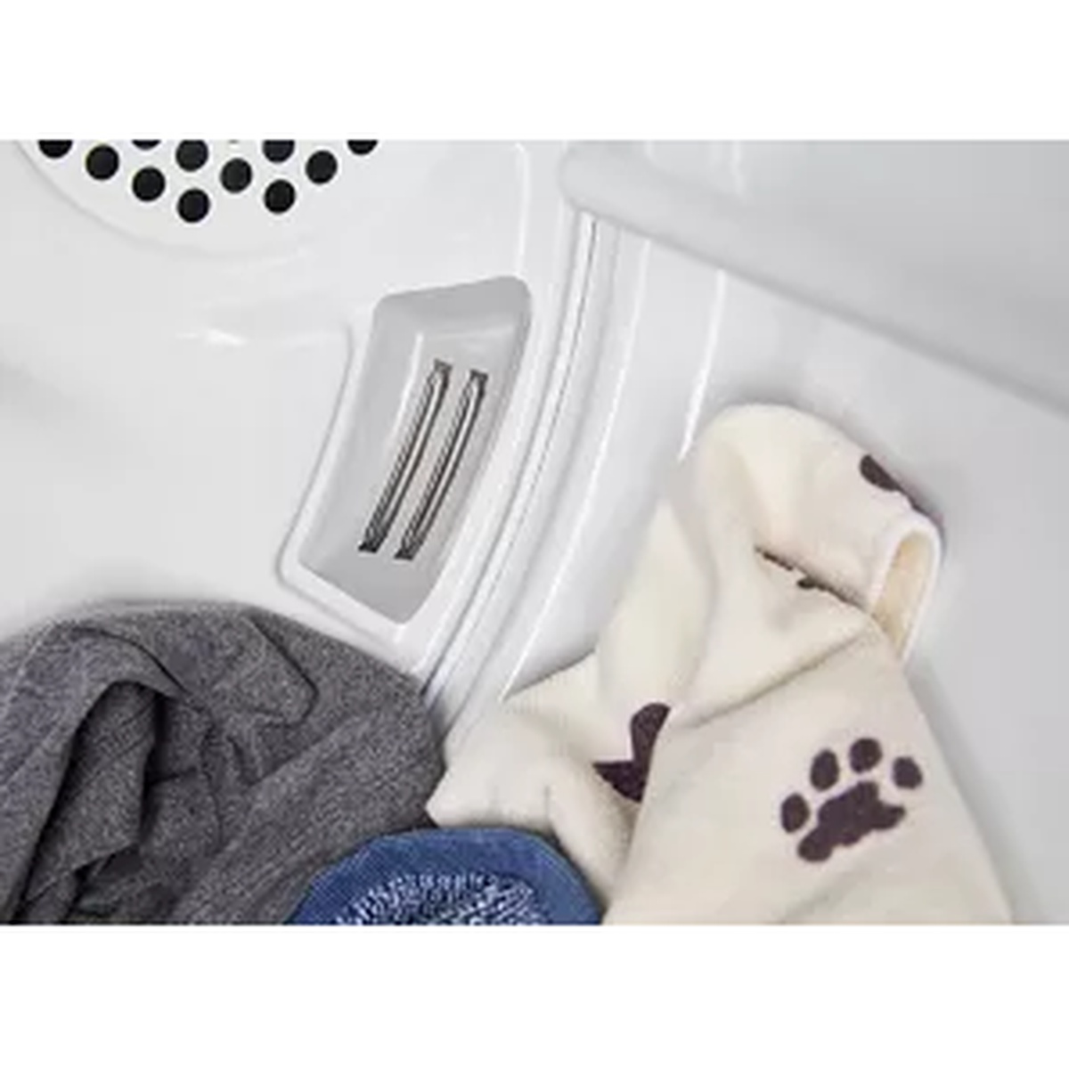Close-up of two moisture sensing bars inside the Maytag dryer drum alongside a variety of laundry items