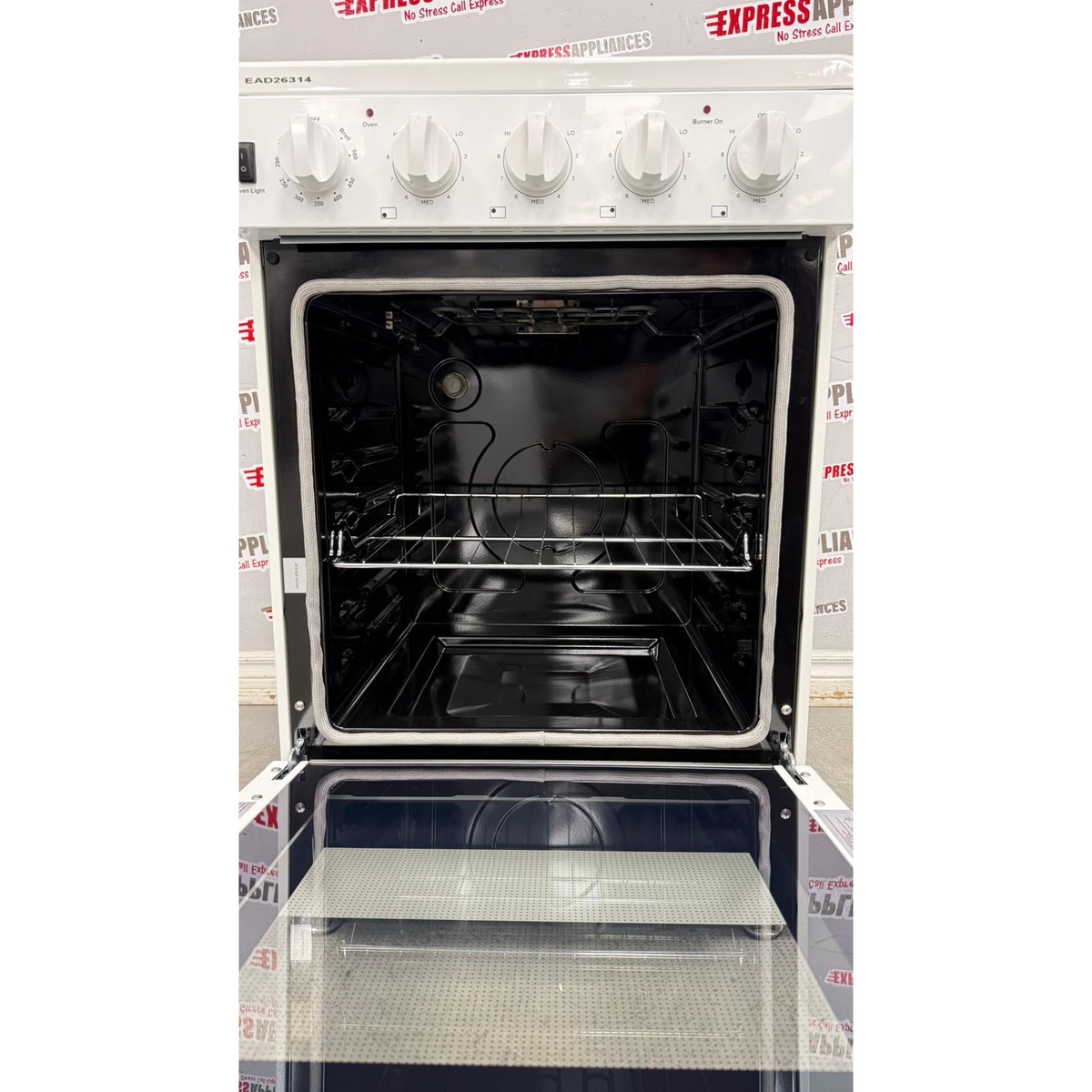 Open oven cavity with adjustable rack inside the white Elements slide-in electric range