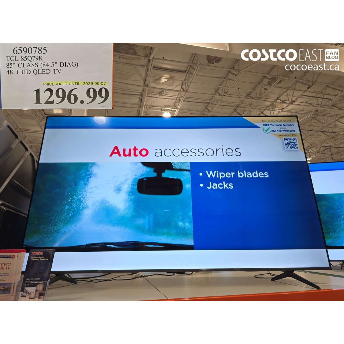 TCL 85Q79K 85 class 4K UHD QLED TV on a display table in a warehouse store