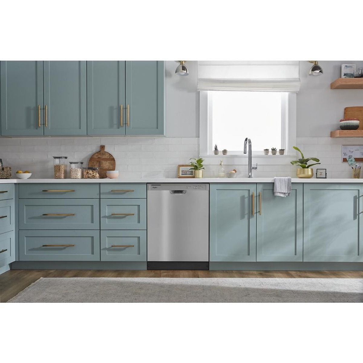 Stainless steel Whirlpool dishwasher installed under a kitchen counter with front controls