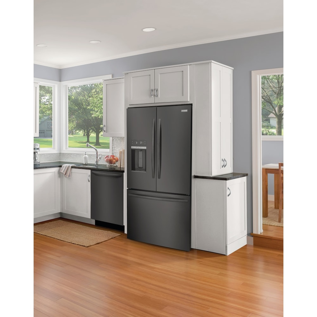 Frigidaire black stainless steel French door refrigerator installed between kitchen cabinets.