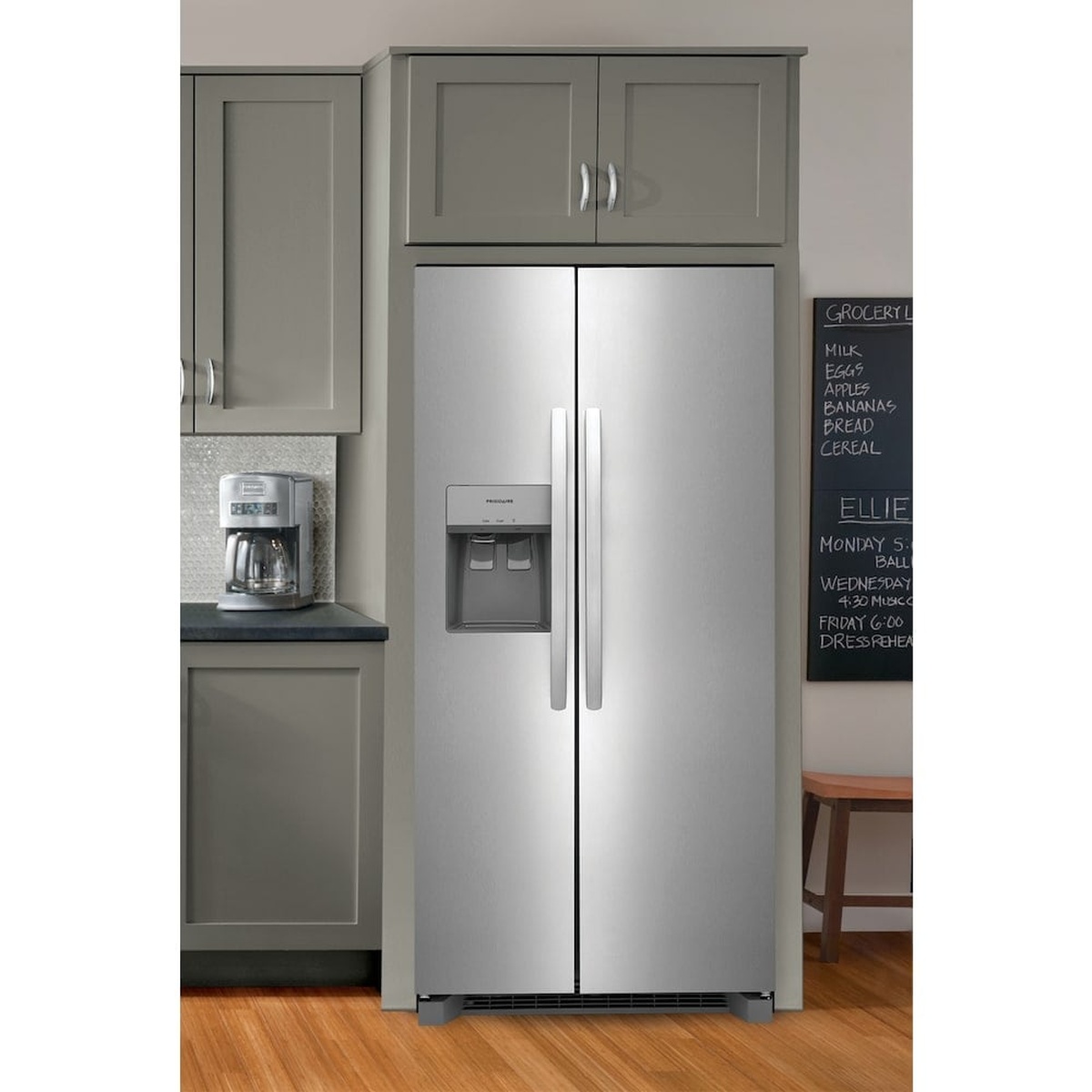 Stainless steel Frigidaire side-by-side refrigerator installed in a kitchen with an external ice and water dispenser